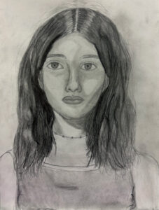 A pencil drawing of a woman with long hair.