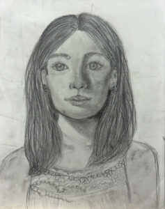 A pencil drawing of a girl with long hair.