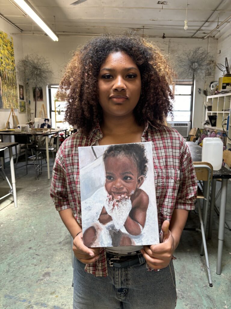 A woman holding up a picture of a baby.