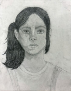 A pencil drawing of a girl with long hair.