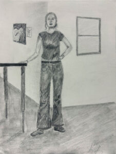 A woman standing in front of a table.