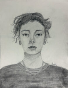 A pencil drawing of a woman with a messy bun.