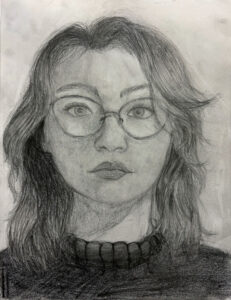 A pencil drawing of a woman with glasses.