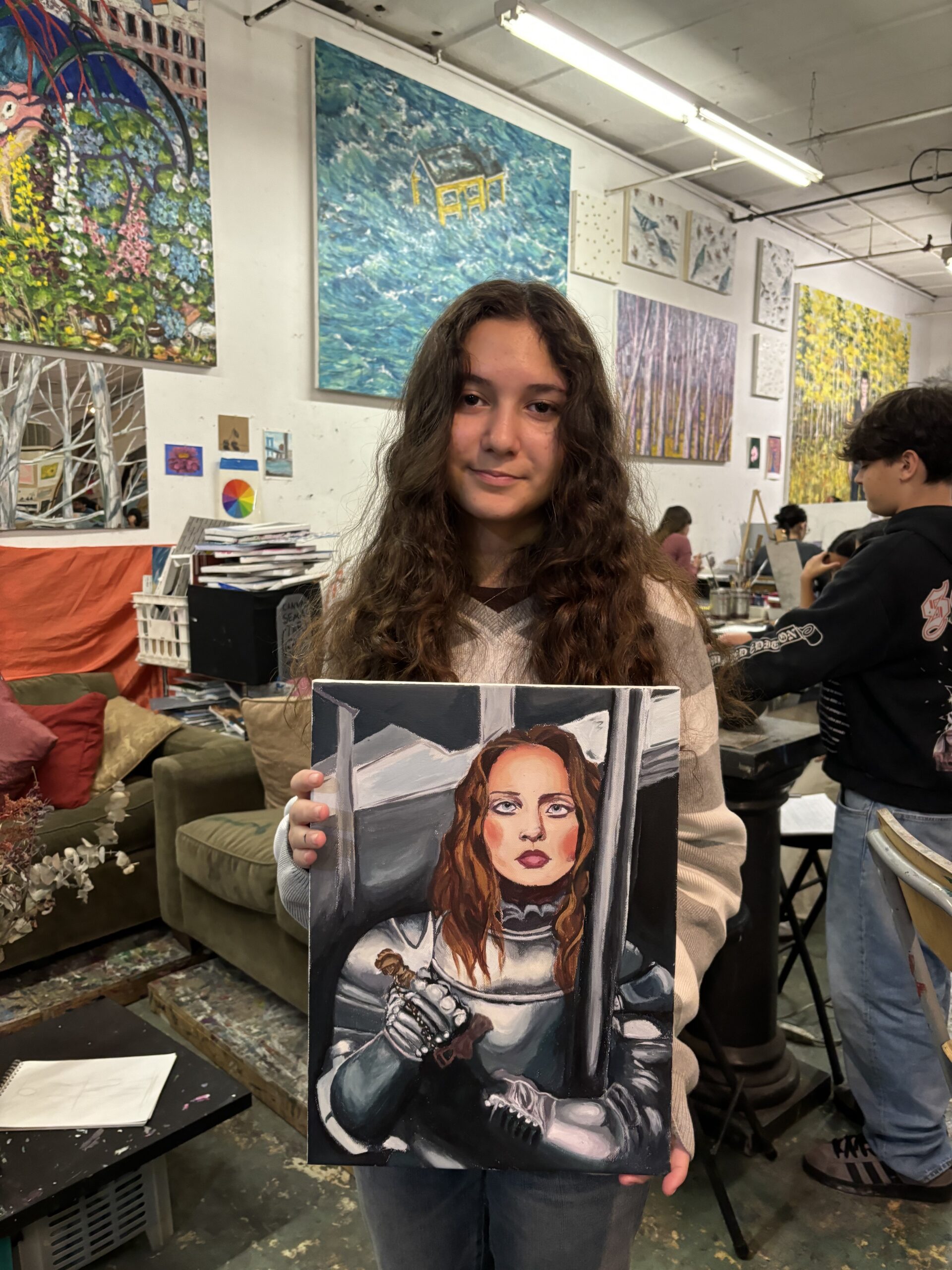 A girl holding up an image of herself.