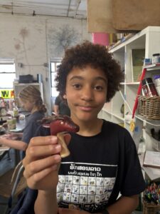 A boy holding an apple in his hand.