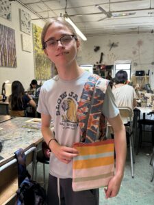 A man holding onto some bags in front of him