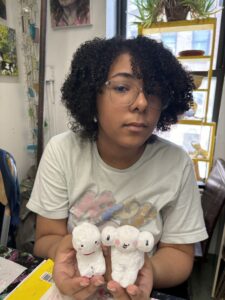 A woman holding two small white mice in her hands.