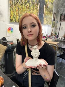 A woman holding a statue in her hands.