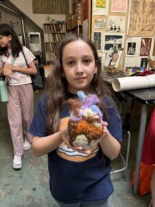 A girl holding an animal in her hands.