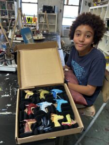 A boy sitting in front of some cookies