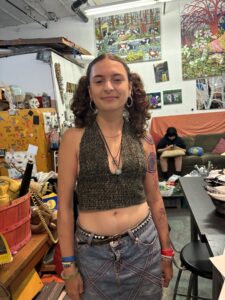 A woman with long hair and a tattoo on her stomach.