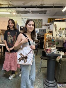 Two girls in a room with some paintings