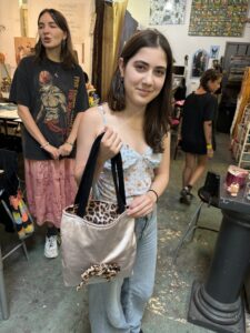 A woman holding onto a leopard print bag