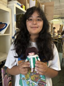 A girl holding a doll in her hands.