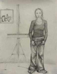 A woman standing in front of an easel.