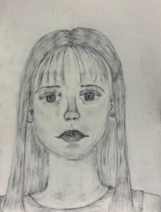 A pencil drawing of a girl with long hair.