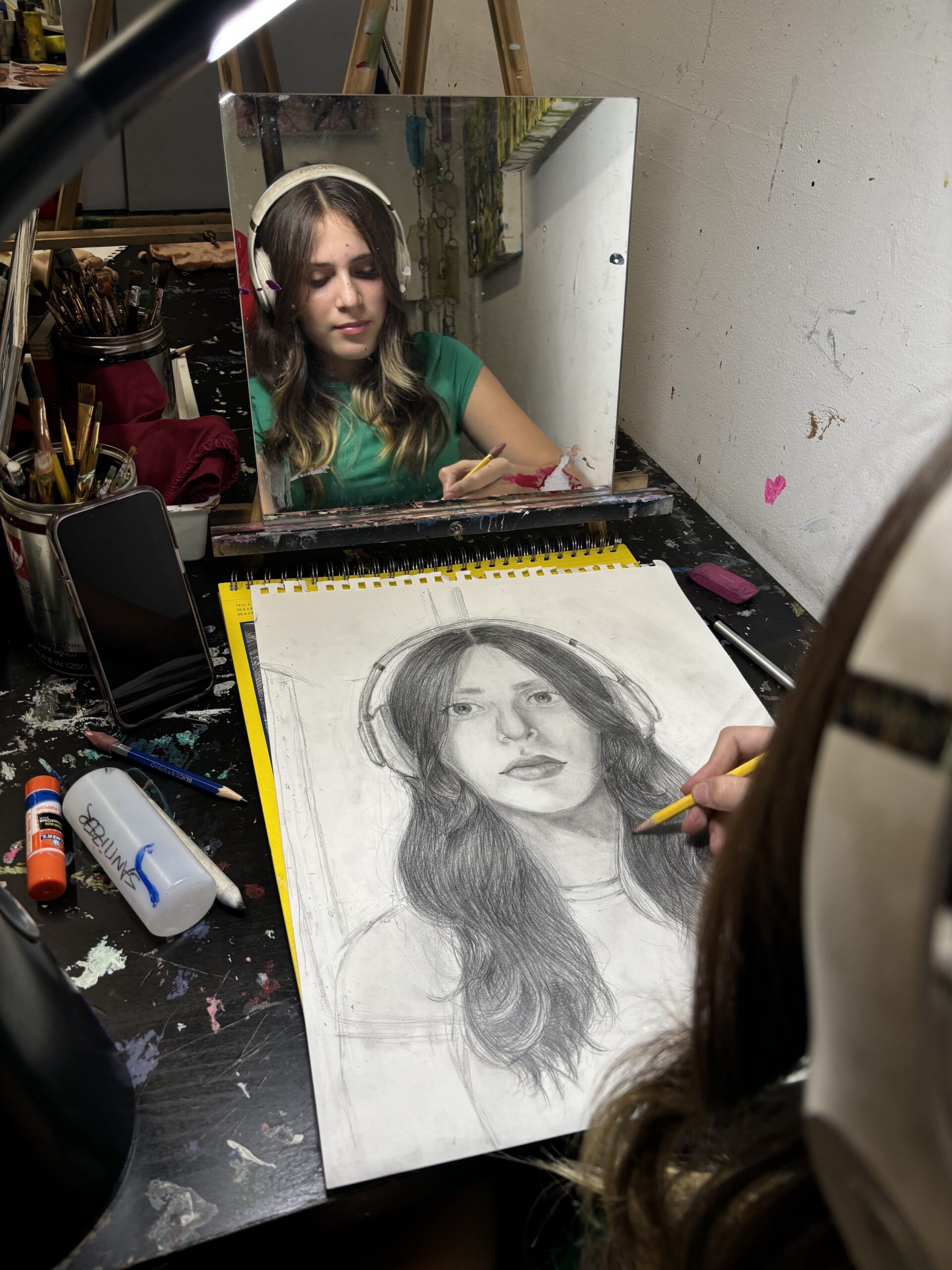 A woman is drawing a picture of herself.