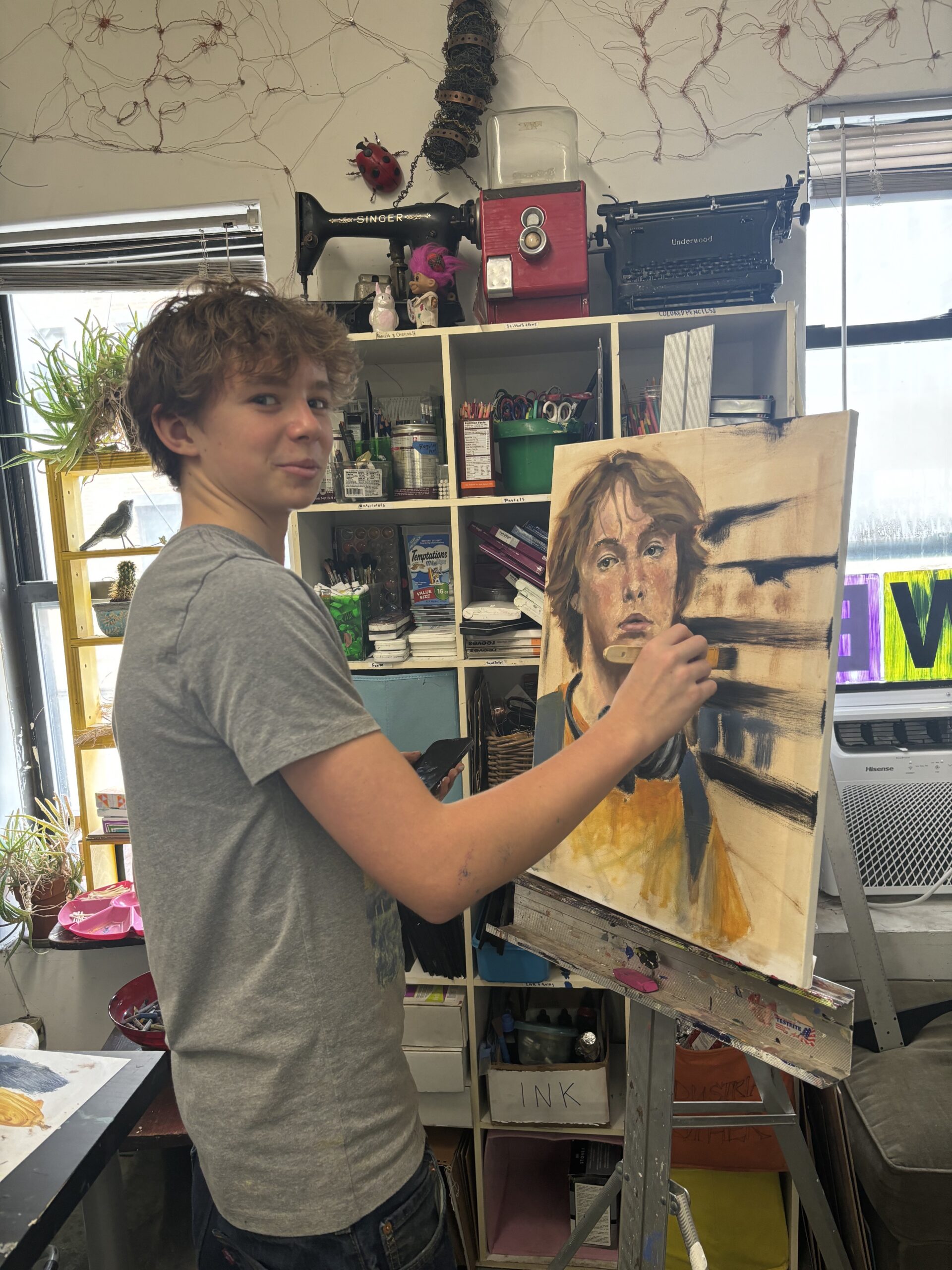 A young man holding up an image of himself.