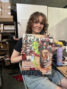 Person holding collage art piece.