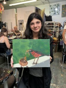 Girl holding bird painting artwork.