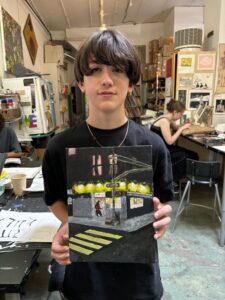 Teen showing off night street painting.