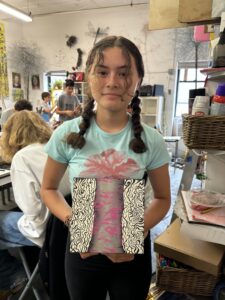 Girl holding abstract art painting.