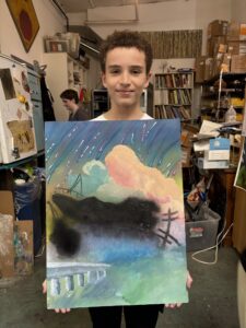 Boy holding abstract landscape painting.