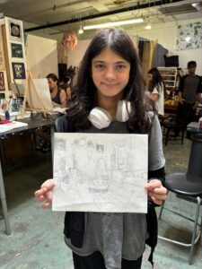 Girl proudly displays her room sketch.