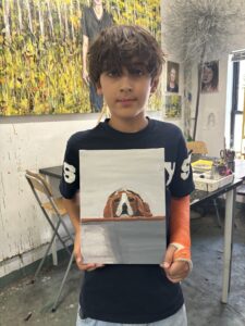 Boy proudly displays his beagle painting.