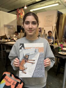 Student shows dog portrait painting.