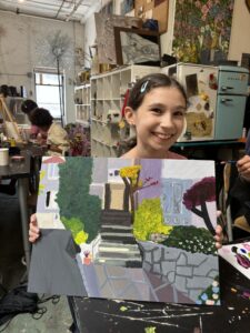 Girl proudly displays her painted house.
