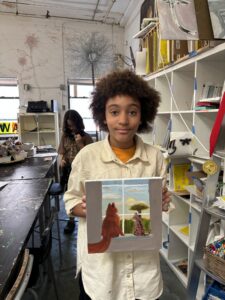 Student showing painting of two cats.