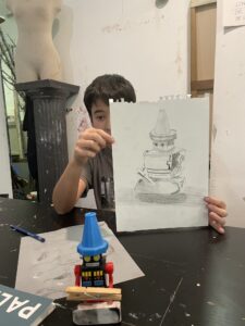 Boy showing his robot drawing.