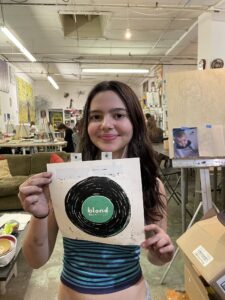 Girl in art class showing Blond print.