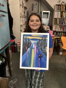 Girl proudly displays her city street painting.