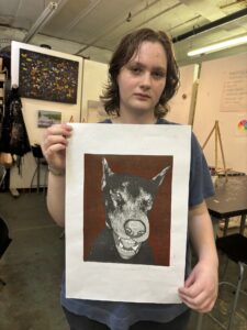 Person holding a dog linocut print.