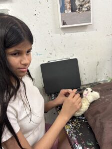 A girl grooming a rabbit indoors.