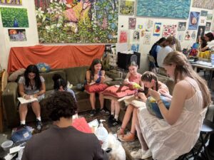 A group of people reading together in a cozy indoor setting.