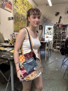 Young woman wearing a fashionable layered dress in an art studio.