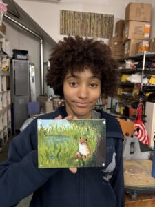 Person holding a painting of a duck in greenery.