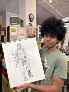 Young artist proudly displays his detailed pencil sketch in an art studio.