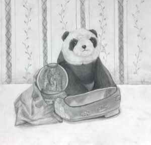 A stuffed panda toy sitting inside an open suitcase on a table.