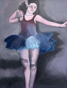 A ballerina in a blue tutu poised mid-dance.